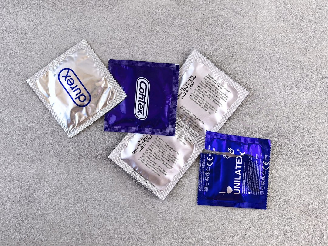 Services several-individually-wrapped-condoms-on-a-gray-surface-ecjjtiqsrx8